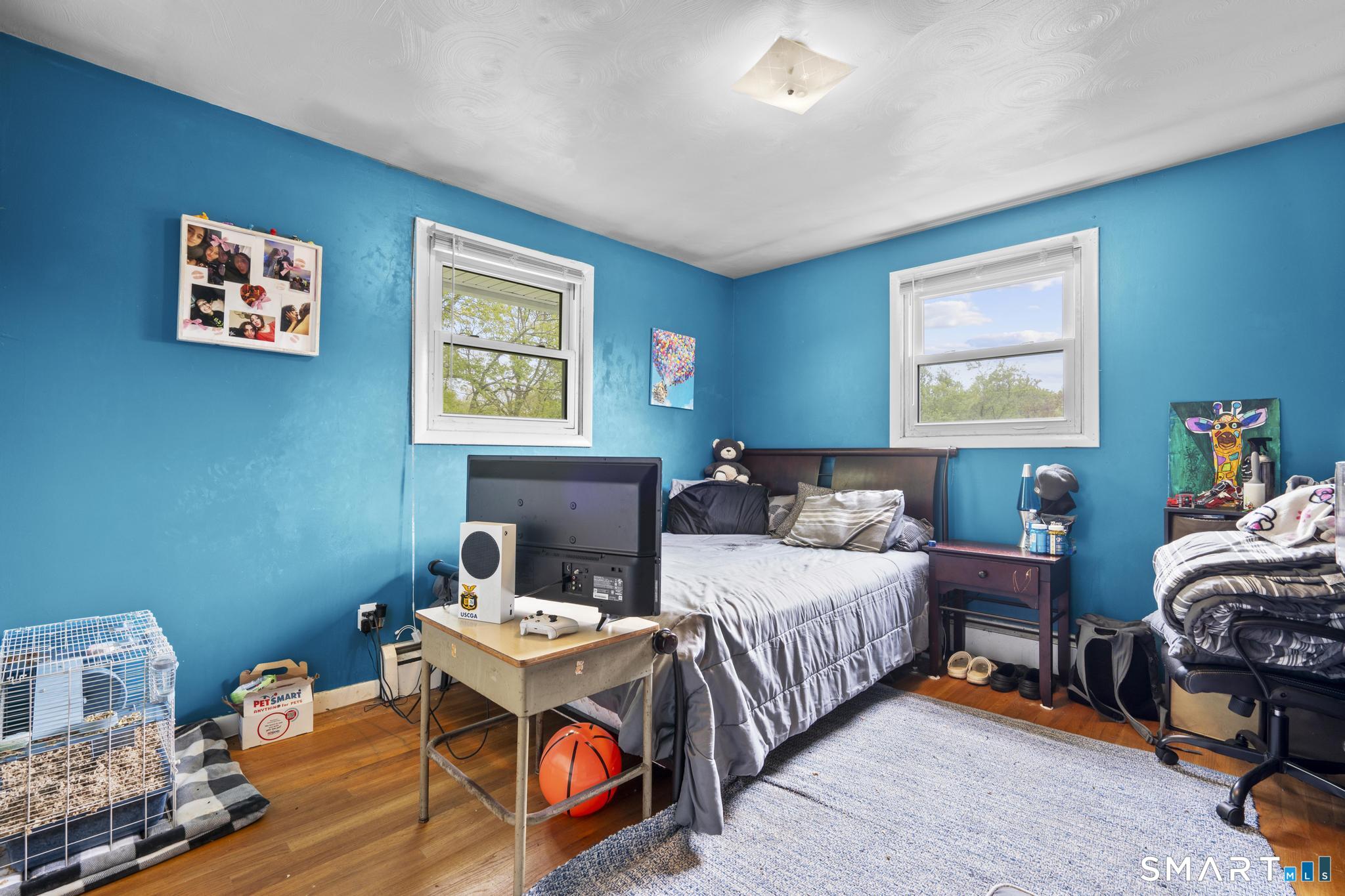79 Forest View Drive Wolcott, CT 06716 - Photo 22 of 28 a bedroom with a bed and a table in it
