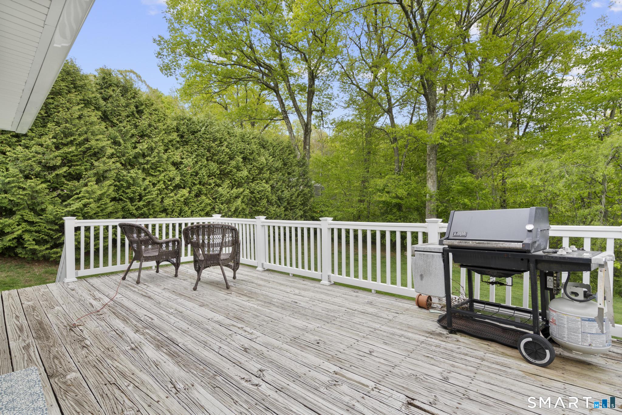79 Forest View Drive Wolcott, CT 06716 - Photo 7 of 28 a view of a deck with chairs a barbeque with wooden floor and fence