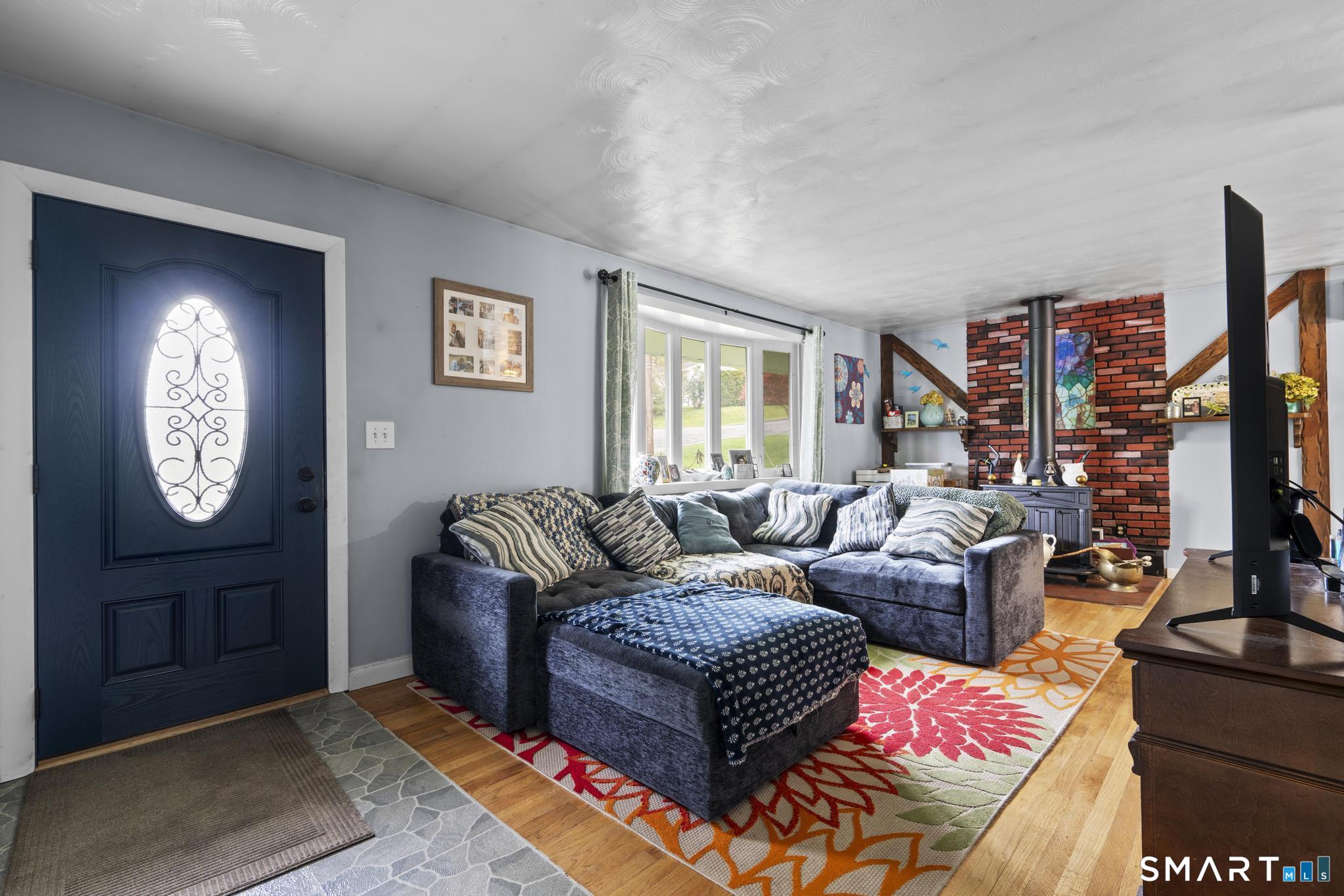 79 Forest View Drive Wolcott, CT 06716 - Photo 9 of 28 a living room with furniture a rug and a window