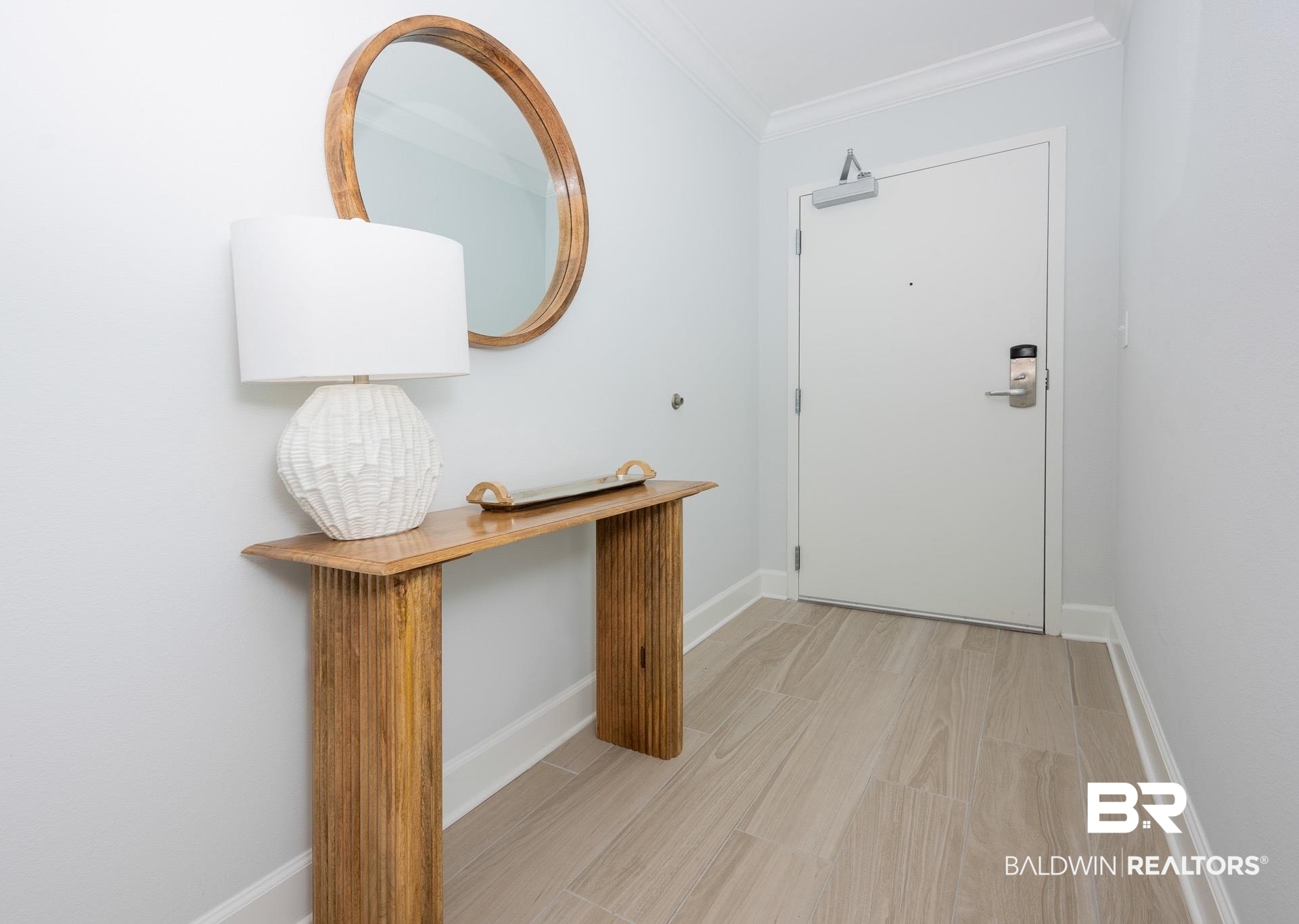 23008 Perdido Beach Boulevard, Unit 506 Orange Beach, AL 36561 - Photo 2 of 48 Doorway to outside with crown molding, baseboards, and light wood finished floors