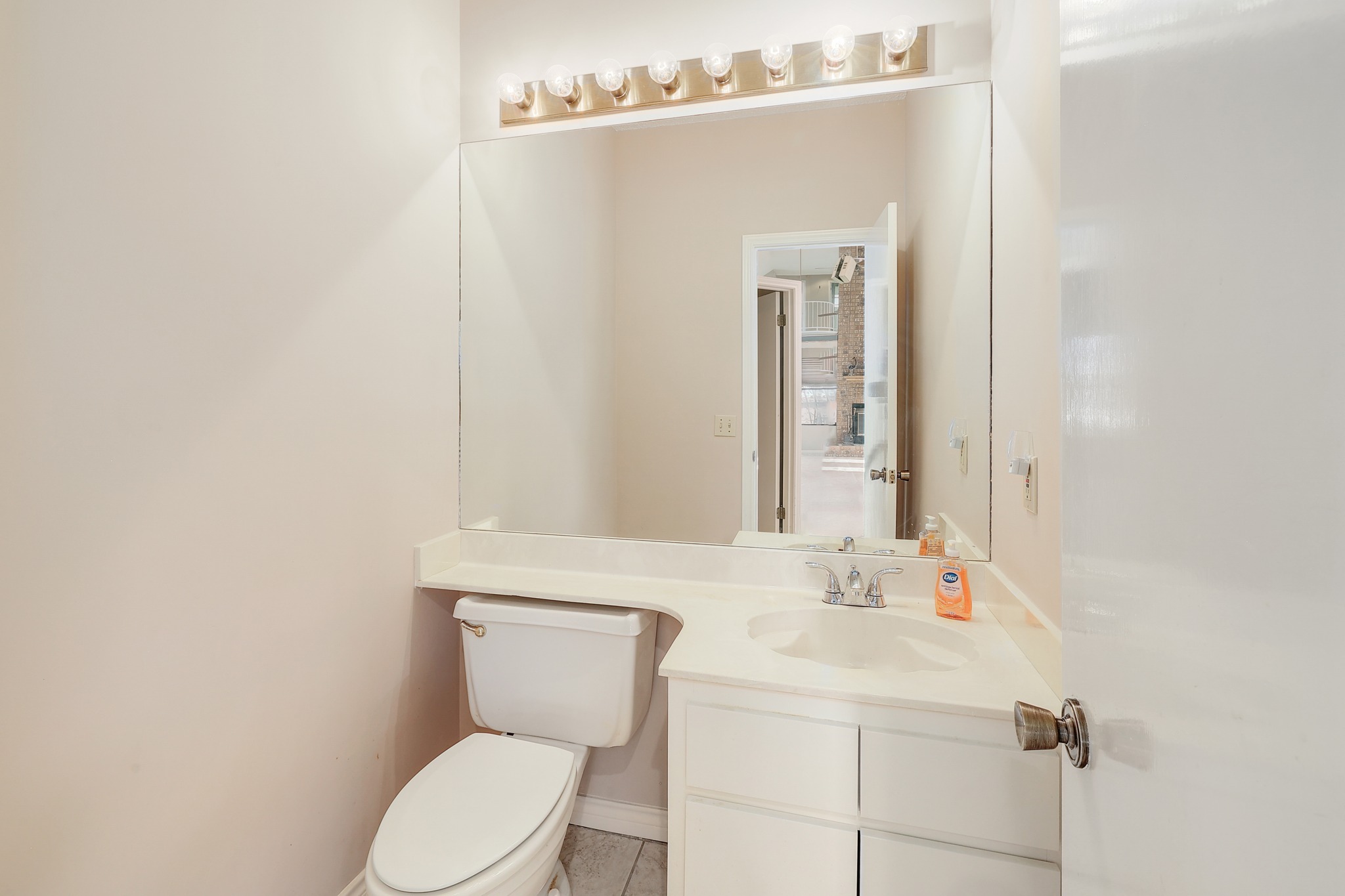 2202 Warfield Way Austin, TX 78728 - Photo 27 of 32 A bright, compact bathroom offers a functional vanity with a broad mirror and sleek fixtures.