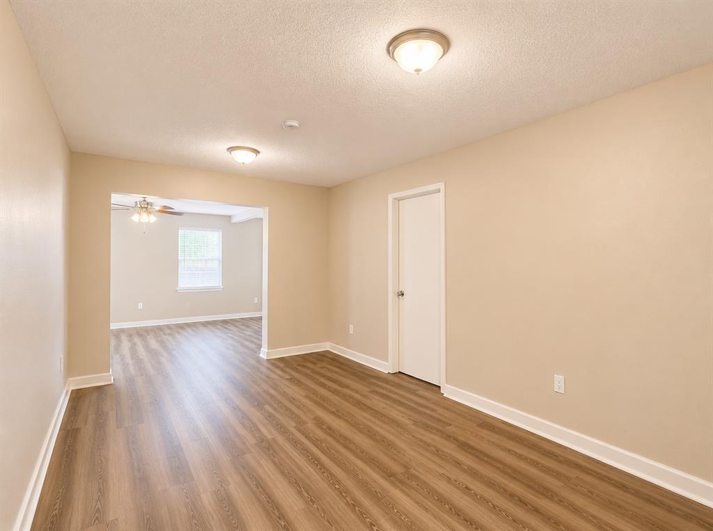 1231 Rutherford Drive Mesquite, TX 75149 - Photo 21 of 29 an empty room with wooden floor and windows