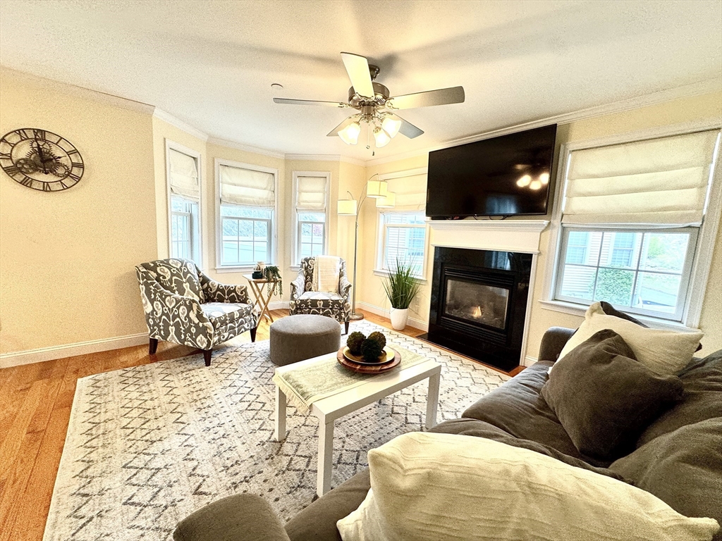2 B Gates Lane, Unit B Wakefield, MA 01880 - Photo 12 of 42 a living room with furniture a flat screen tv and a fireplace
