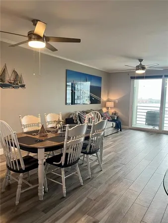 a view of a dining room with furniture and wooden floor