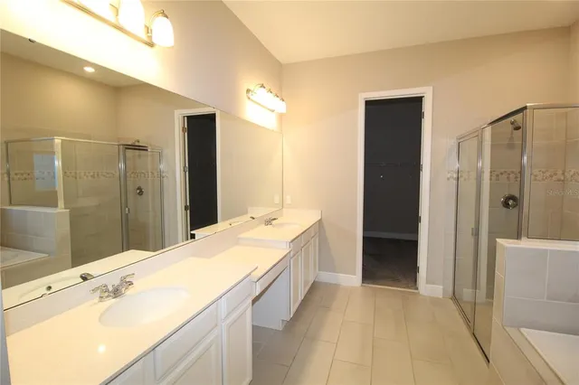 a spacious bathroom with a shower and a tub