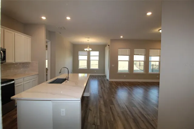 a view of livingroom with kitchen and hardwood