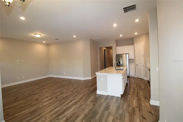 a view of a kitchen and a sink with wooden floor