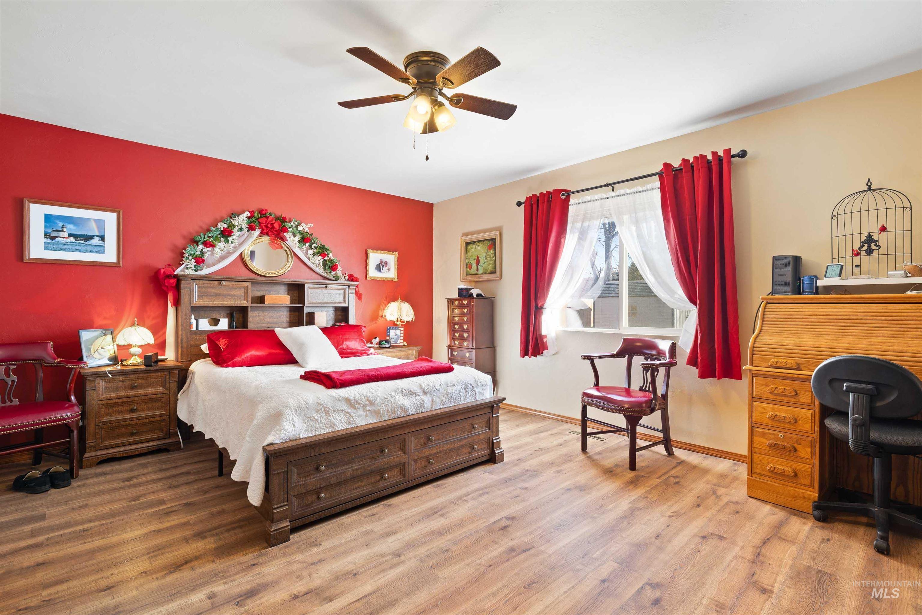 430 Pierce Street Twin Falls, ID 83301 - Photo 12 of 39 Bedroom with wood finished floors, ceiling fan, and an accent wall