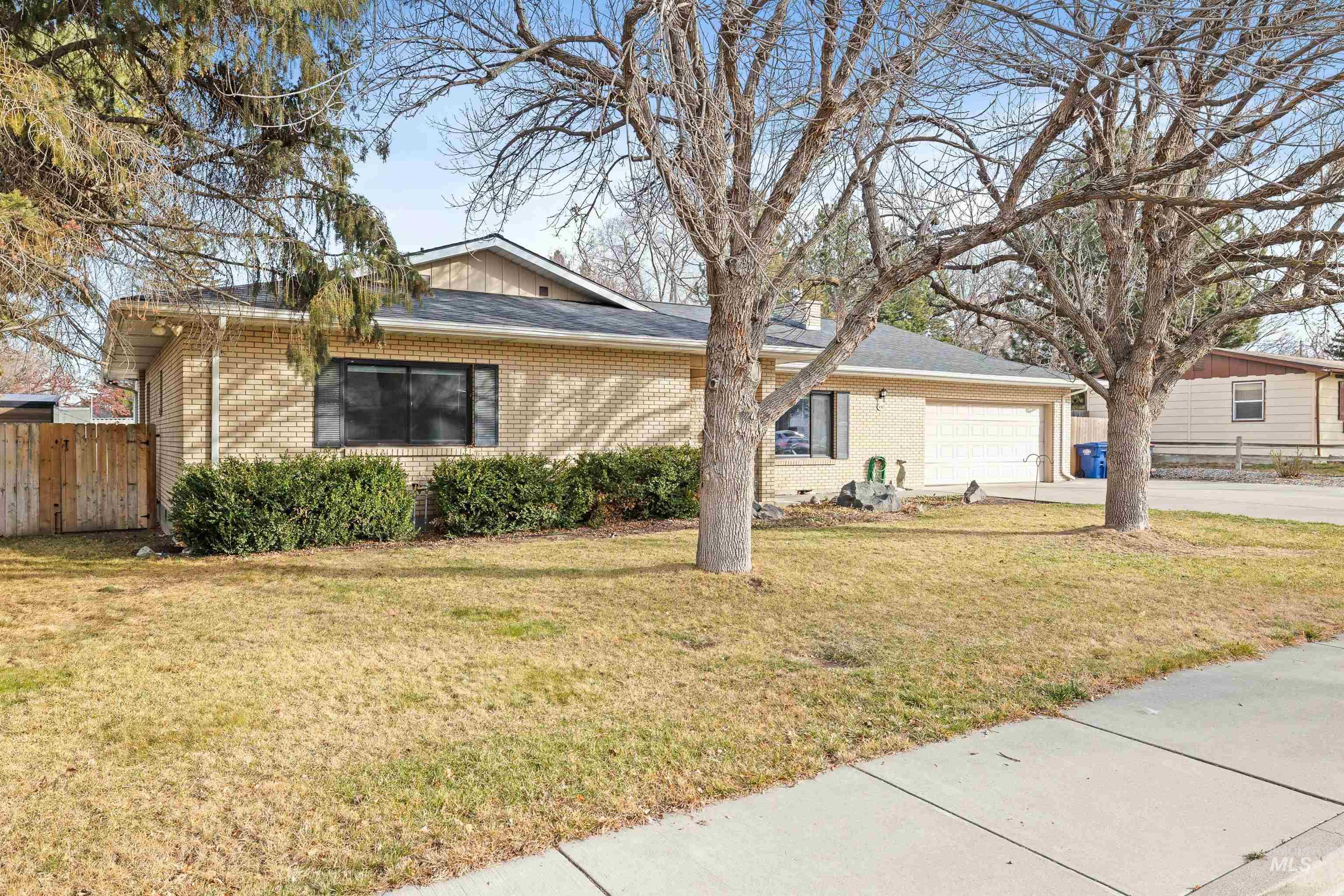 430 Pierce Street Twin Falls, ID 83301 - Photo 30 of 39 Ranch-style house featuring brick siding, driveway, a garage, and a shingled roof