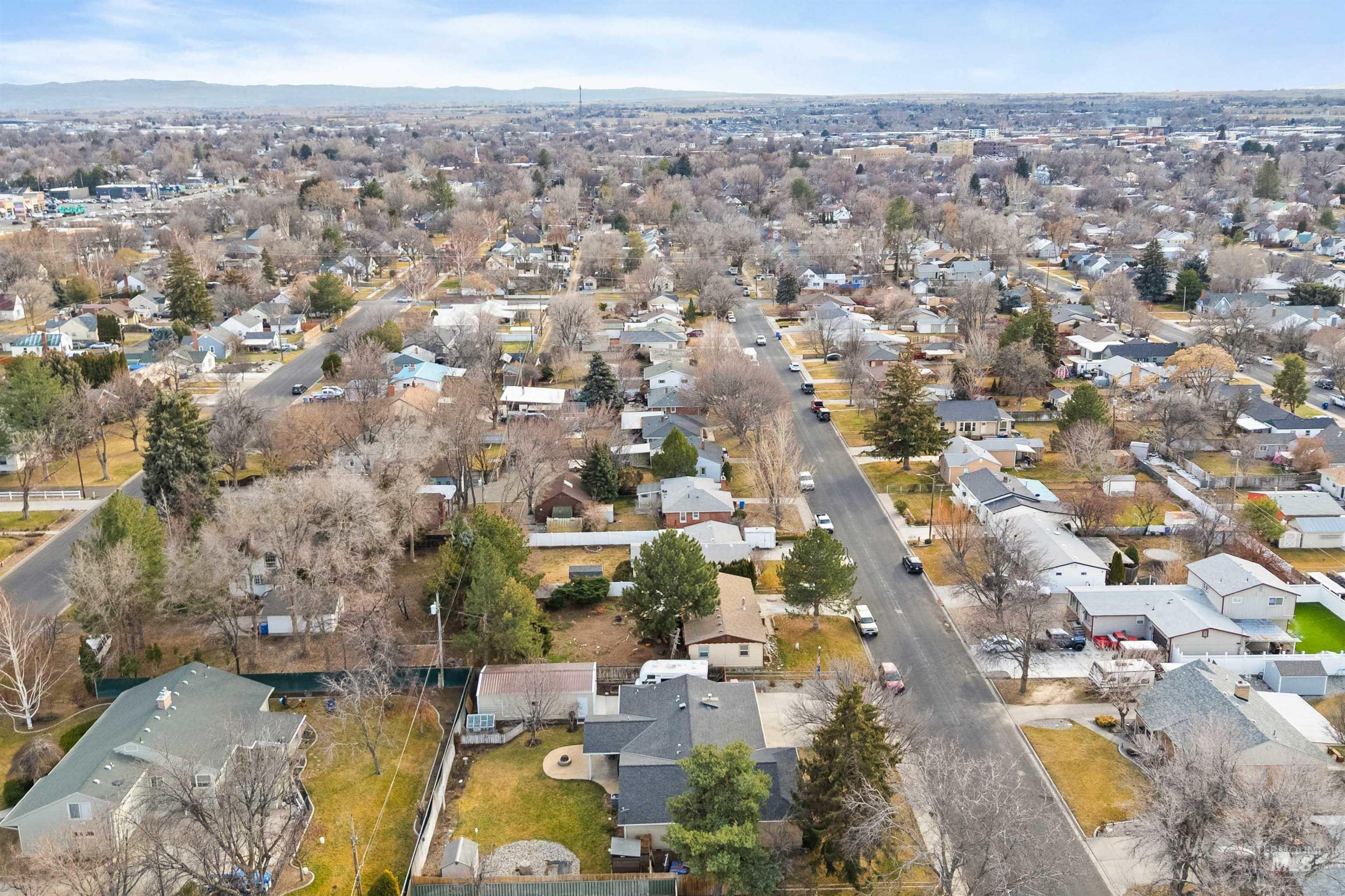 430 Pierce Street Twin Falls, ID 83301 - Photo 34 of 39 Aerial view of property and surrounding area with nearby suburban area and mountains