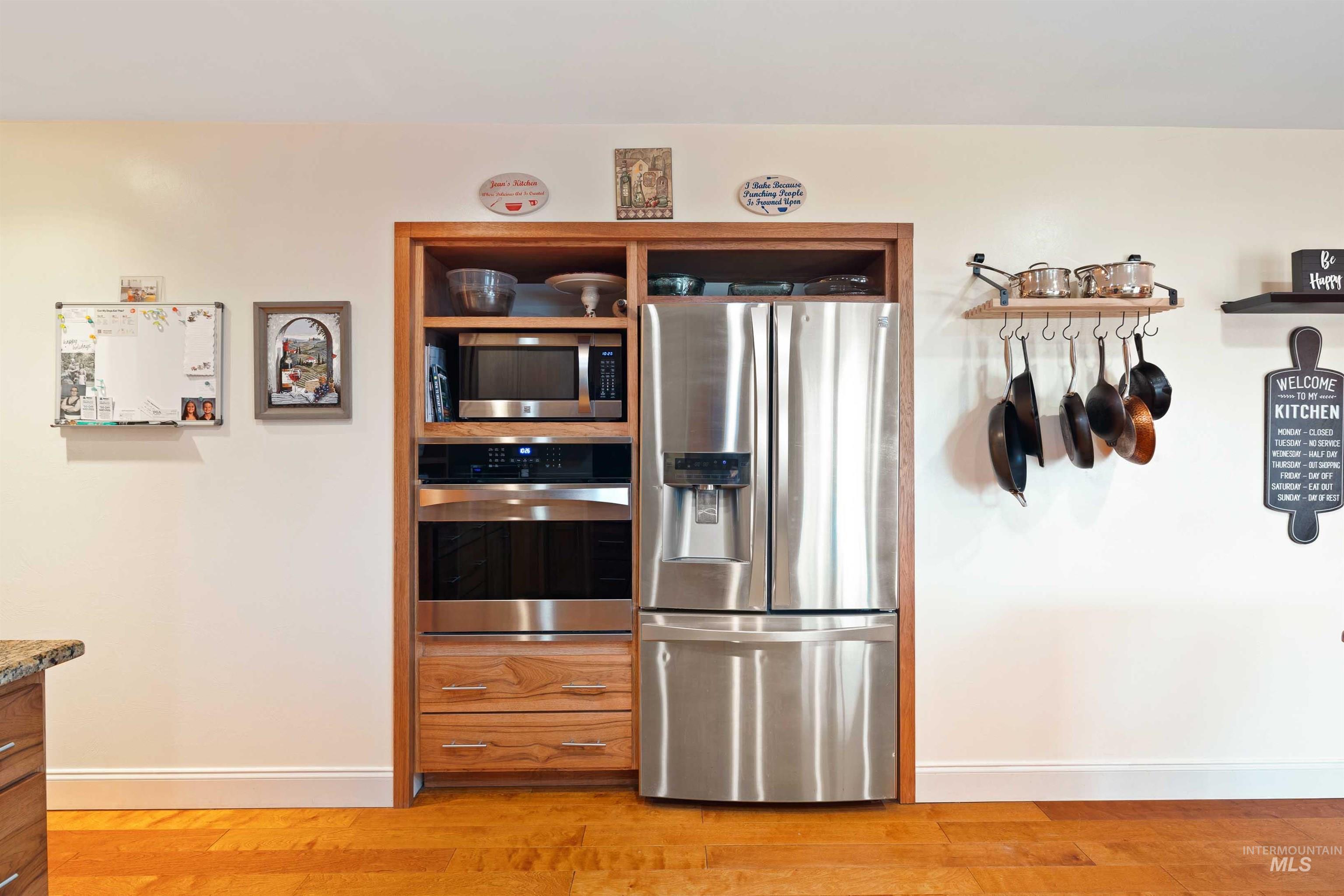 430 Pierce Street Twin Falls, ID 83301 - Photo 10 of 39 Kitchen featuring stainless steel appliances, open shelves, and light wood finished floors