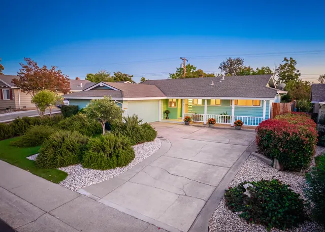 a front view of a house with a yard and outdoor seating