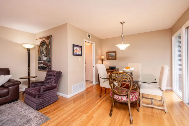 a large kitchen with a lot of counter space and wooden floor