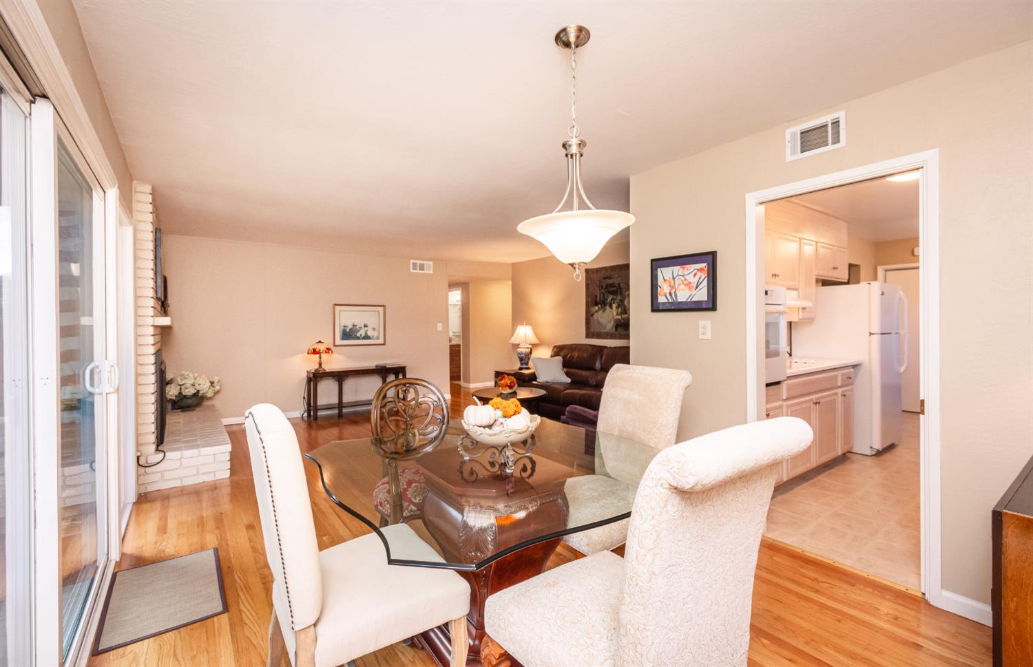 5310 Fort Sutter Way Sacramento, CA 95841 - Photo 17 of 55 a view of a dining room with furniture a chandelier and wooden floor