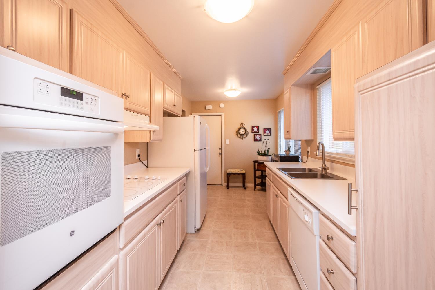 5310 Fort Sutter Way Sacramento, CA 95841 - Photo 19 of 55 a large kitchen with a lot of counter space and wooden floor