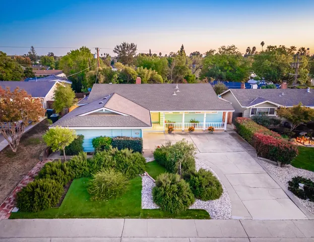 an aerial view of multiple houses with yard
