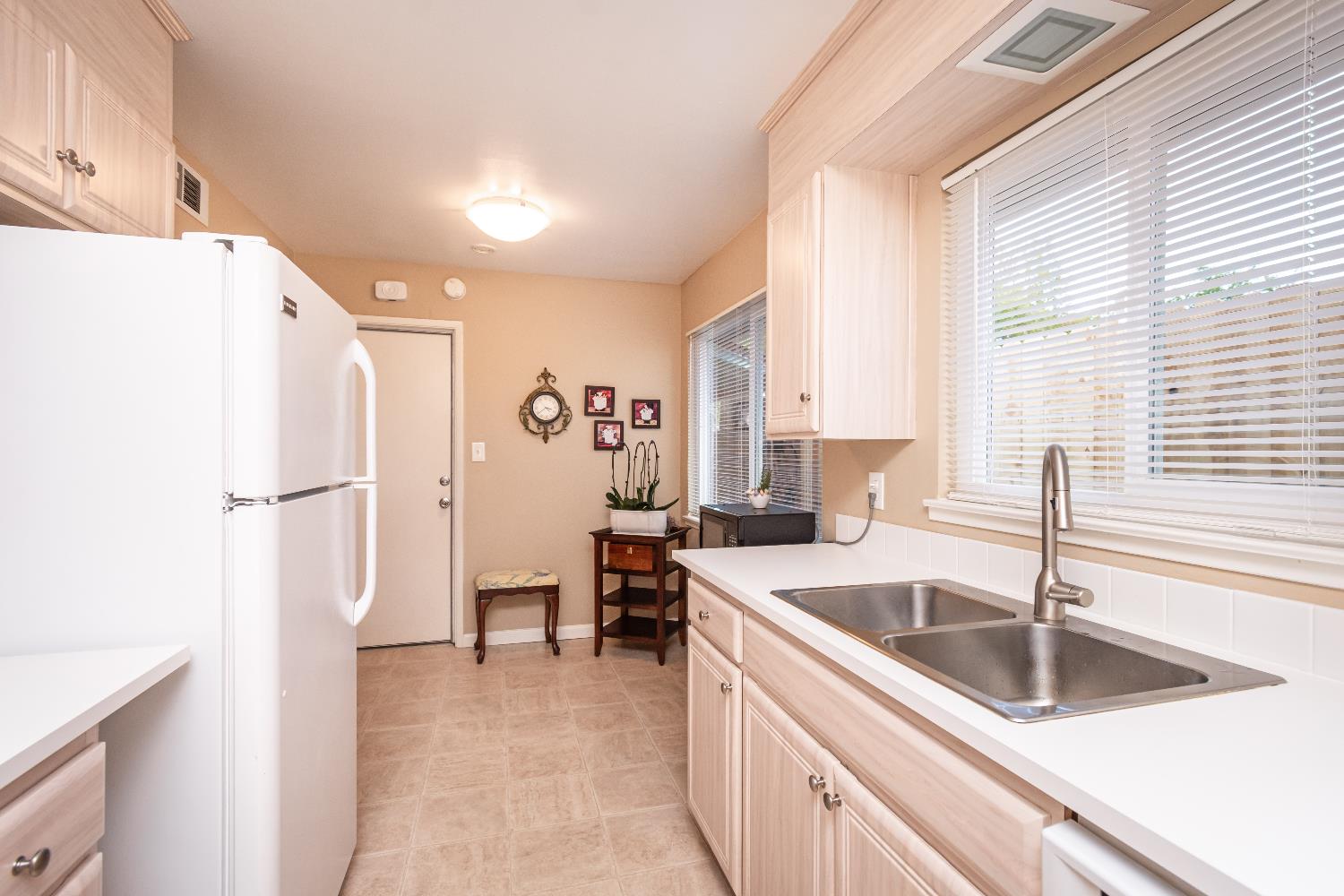 5310 Fort Sutter Way Sacramento, CA 95841 - Photo 21 of 55 a kitchen that has a sink a refrigerator and cabinets