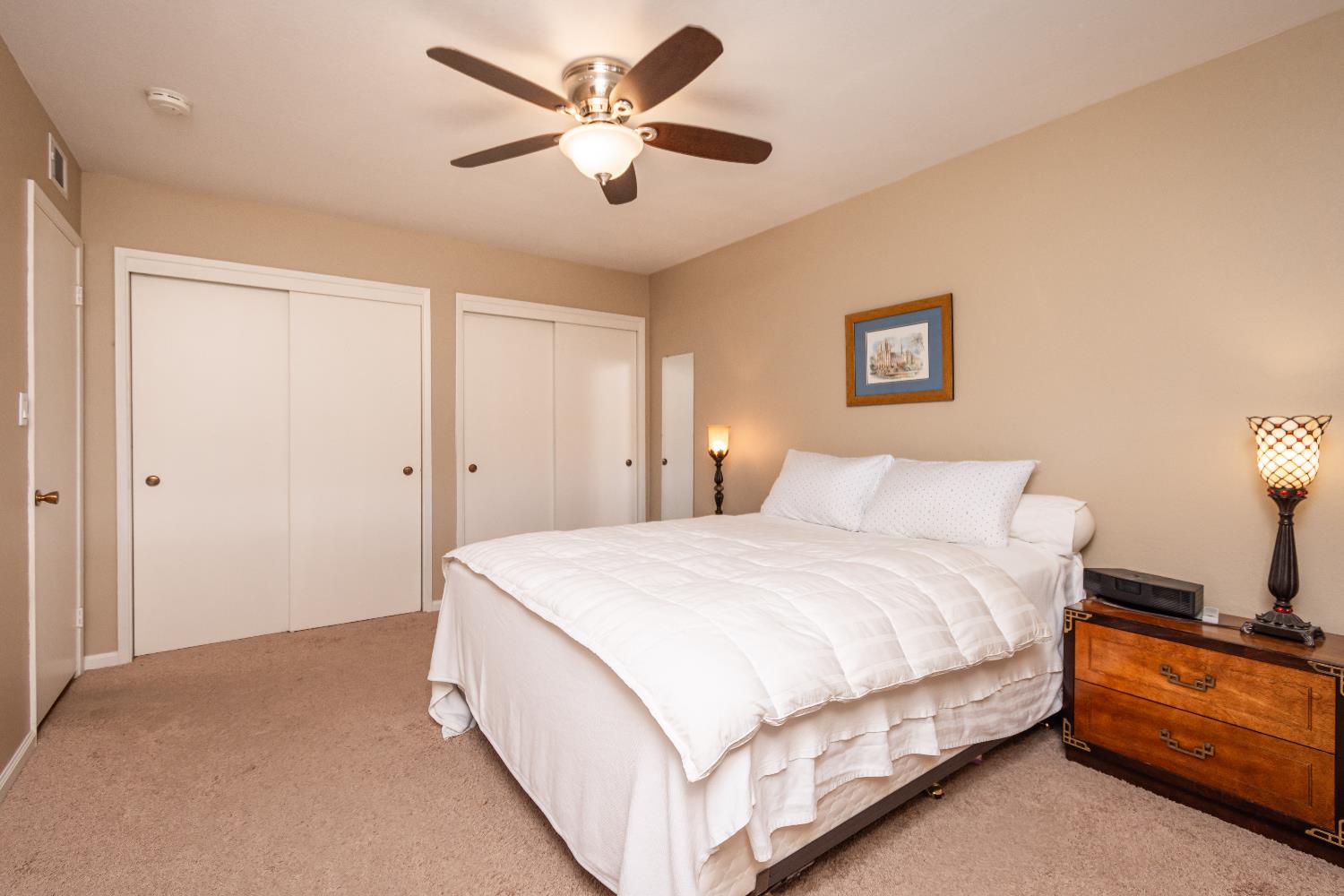 5310 Fort Sutter Way Sacramento, CA 95841 - Photo 29 of 55 a spacious bedroom with a bed and a chandelier