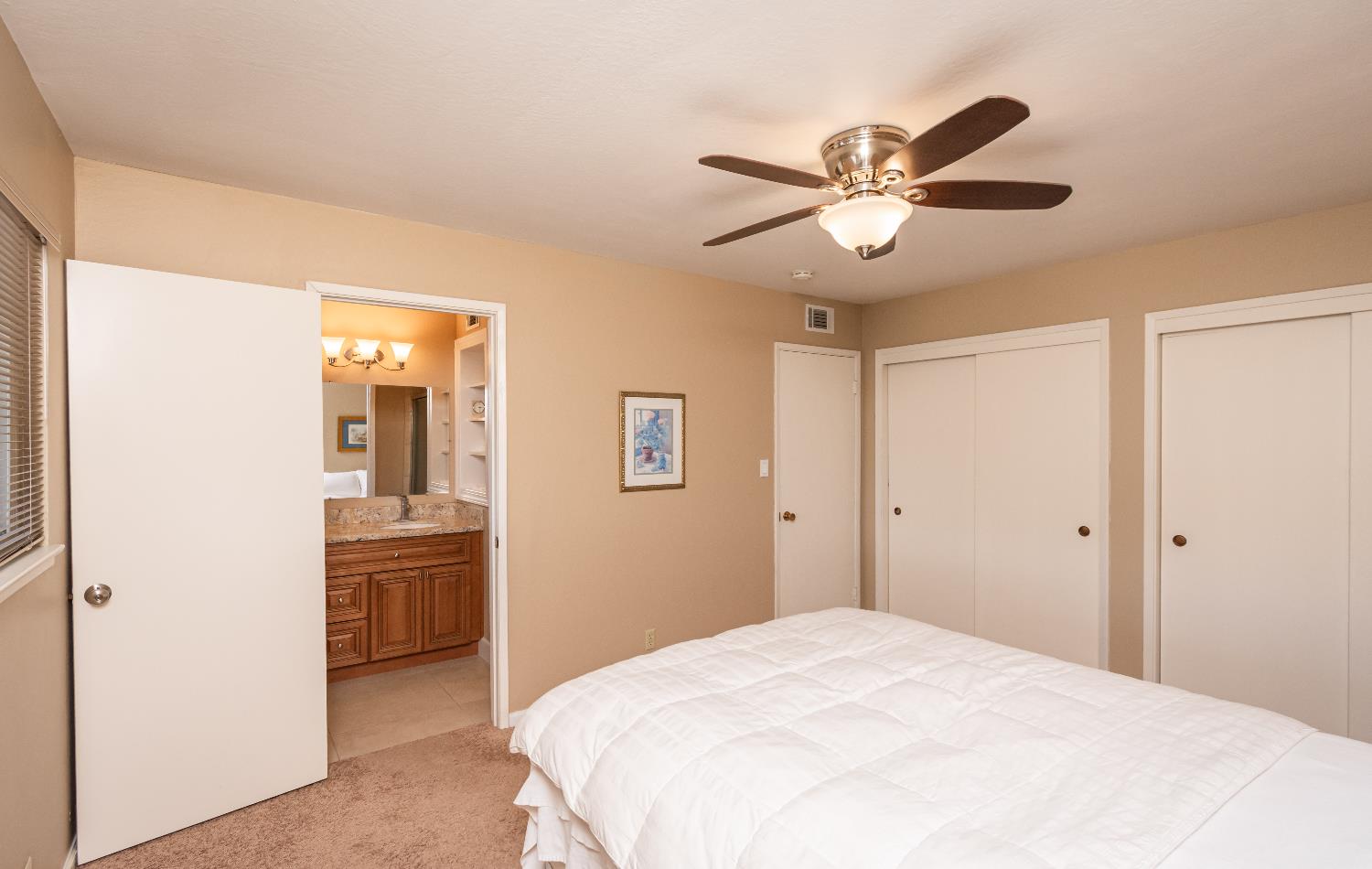 5310 Fort Sutter Way Sacramento, CA 95841 - Photo 31 of 55 a bedroom with a bed and a chandelier