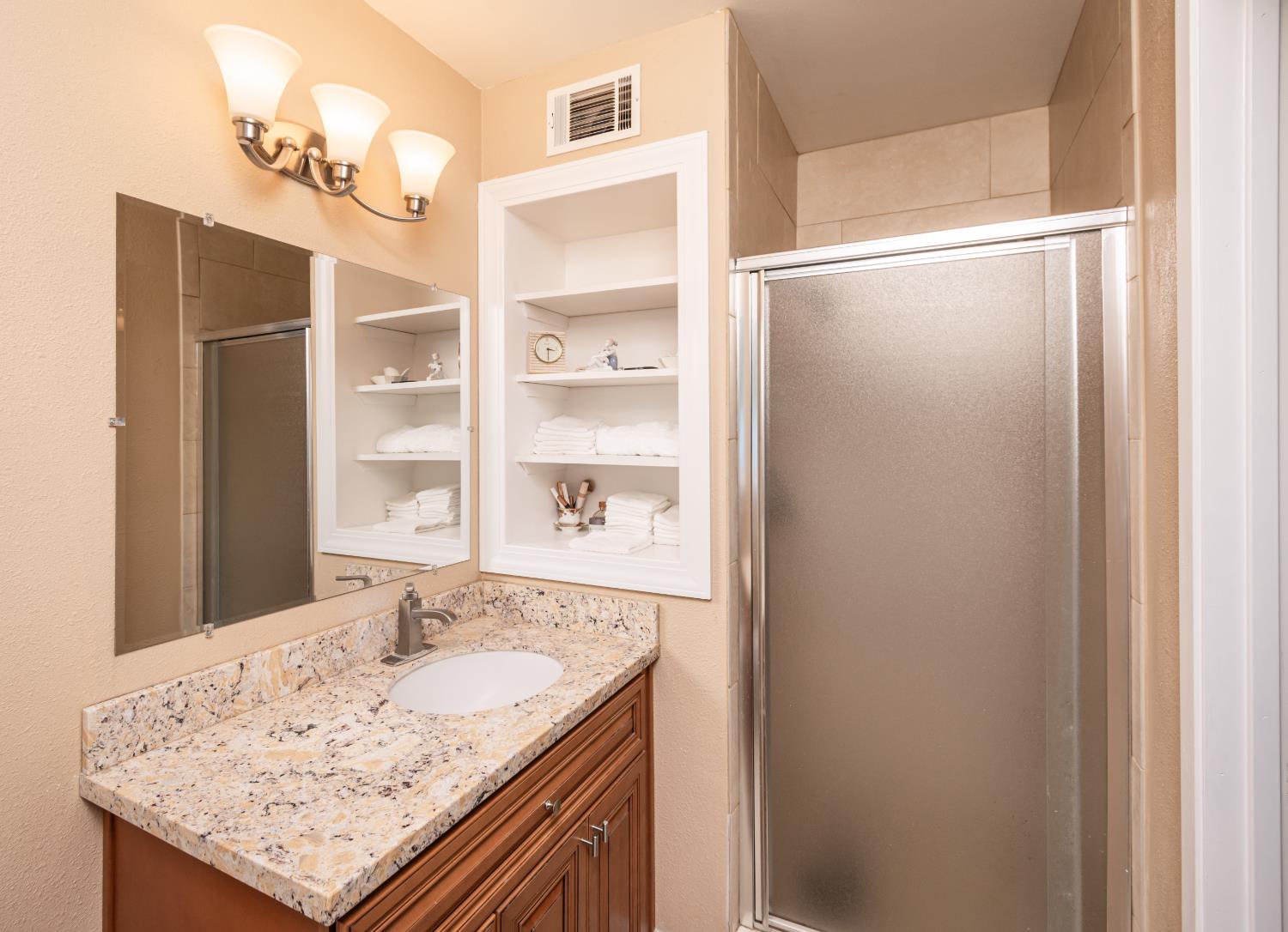 5310 Fort Sutter Way Sacramento, CA 95841 - Photo 33 of 55 a bathroom with a granite countertop sink and shower