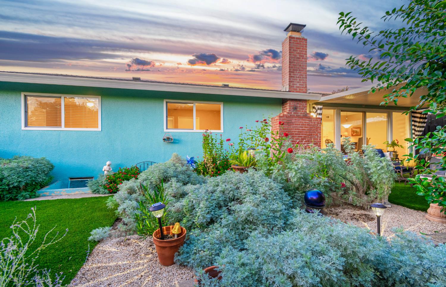5310 Fort Sutter Way Sacramento, CA 95841 - Photo 47 of 55 a front view of a house with a yard and potted plants