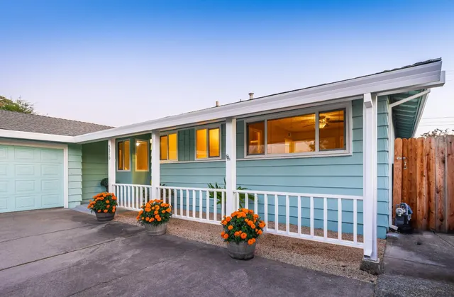 a view of a hallway with wooden floor and dining room