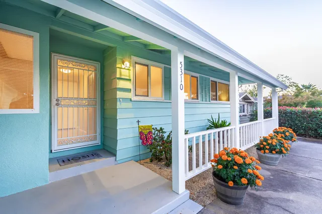 a living room with furniture large window and a fireplace