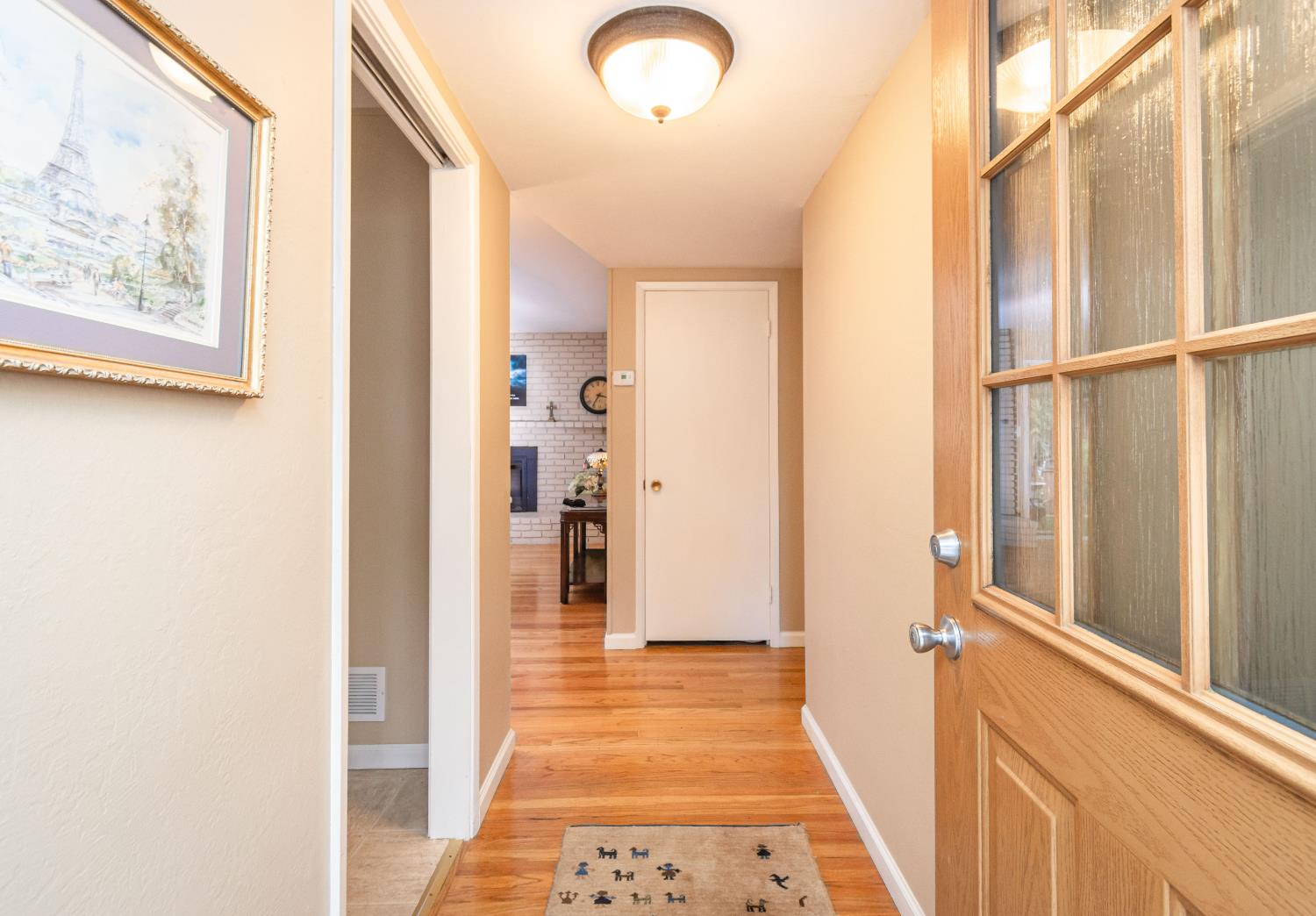 5310 Fort Sutter Way Sacramento, CA 95841 - Photo 10 of 55 a view of a hallway with wooden floor and dining room