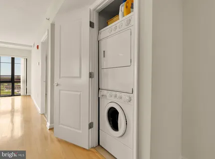 a view of a hallway with washer and dryer