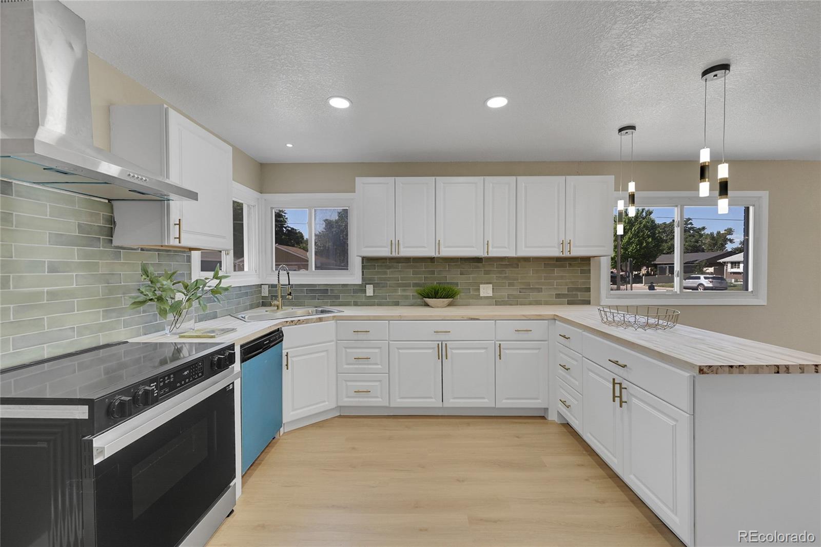 a kitchen with a sink stove and cabinets