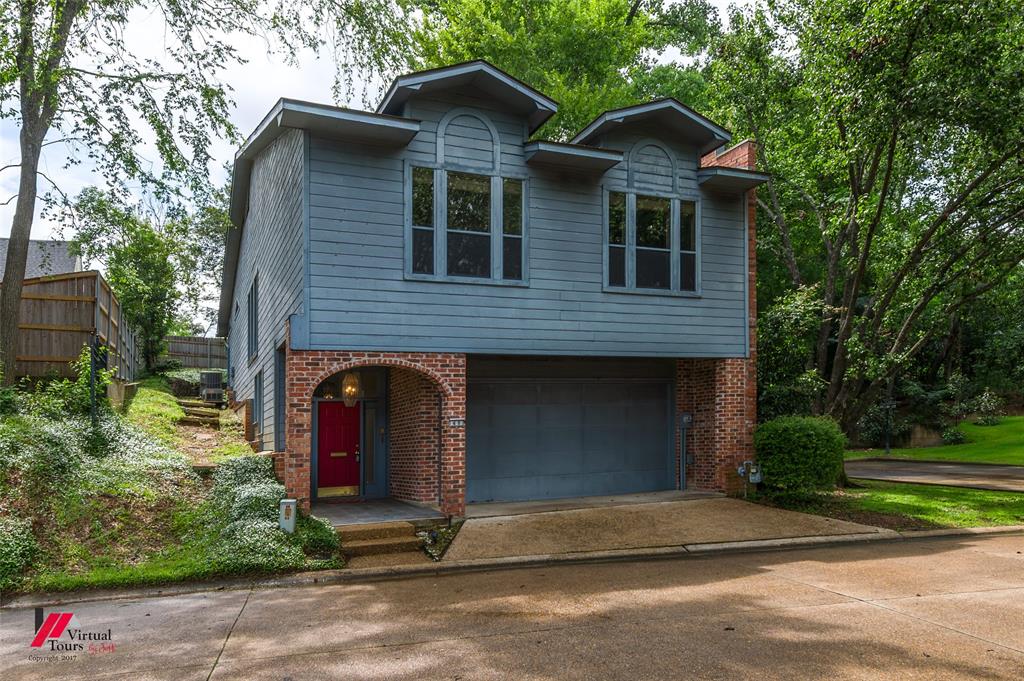 300 Pierremont Road, Unit 40 Shreveport, LA 71106 - Photo 4 of 34 Two-story residence featuring a brick foundation, light blue horizontal siding, and a two-car garage
