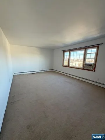an empty room with a empty space and windows