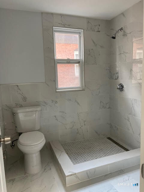 666 Capitol Avenue, Unit 2 Bridgeport, CT 06606 - Photo 12 of 14 a bathroom with a toilet and a shower
