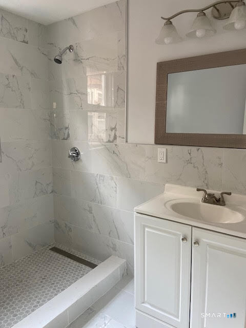 666 Capitol Avenue, Unit 2 Bridgeport, CT 06606 - Photo 13 of 14 a bathroom with a sink and a mirror