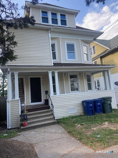 666 Capitol Avenue, Unit 2 Bridgeport, CT 06606 - Photo 2 of 14 a view of a house with a small yard and large tree