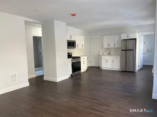a view of a kitchen with a sink and a refrigerator
