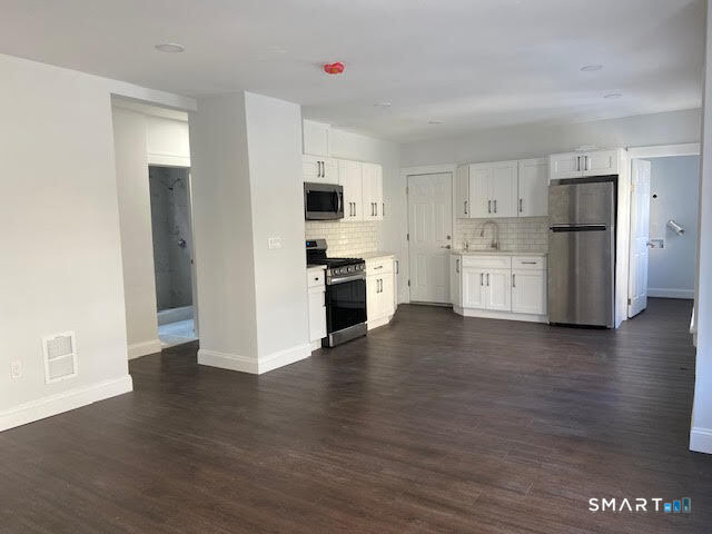 666 Capitol Avenue, Unit 2 Bridgeport, CT 06606 - Photo 5 of 14 a view of a kitchen with a sink and a refrigerator