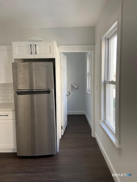 666 Capitol Avenue, Unit 2 Bridgeport, CT 06606 - Photo 6 of 14 a view of a refrigerator in kitchen and an empty room