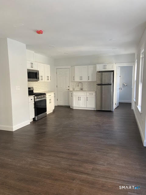 666 Capitol Avenue, Unit 2 Bridgeport, CT 06606 - Photo 8 of 14 a view of kitchen with wooden floor