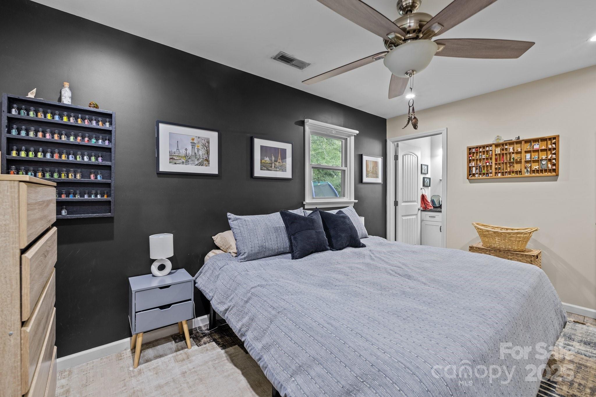 1108 Willoughby Road Monroe, NC 28110 - Photo 15 of 40 a bedroom with a bed and a chandelier