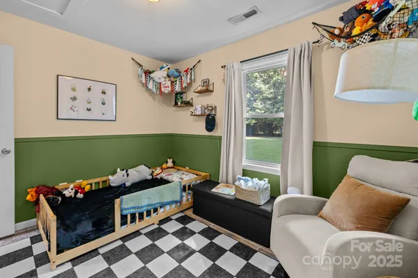 a room with furniture toys and a large window