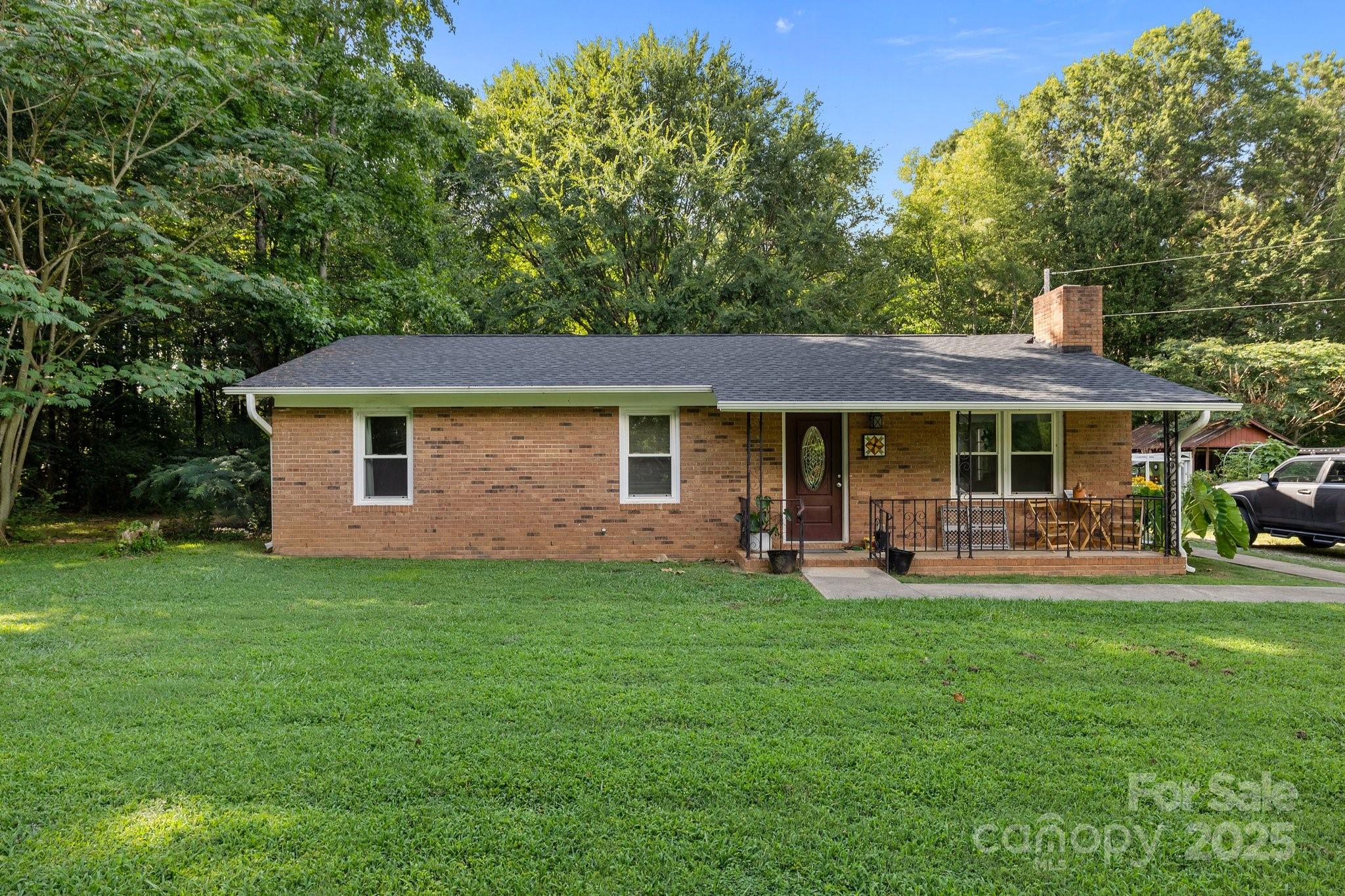 1108 Willoughby Road Monroe, NC 28110 - Photo 2 of 40 a front view of a house with a garden and patio