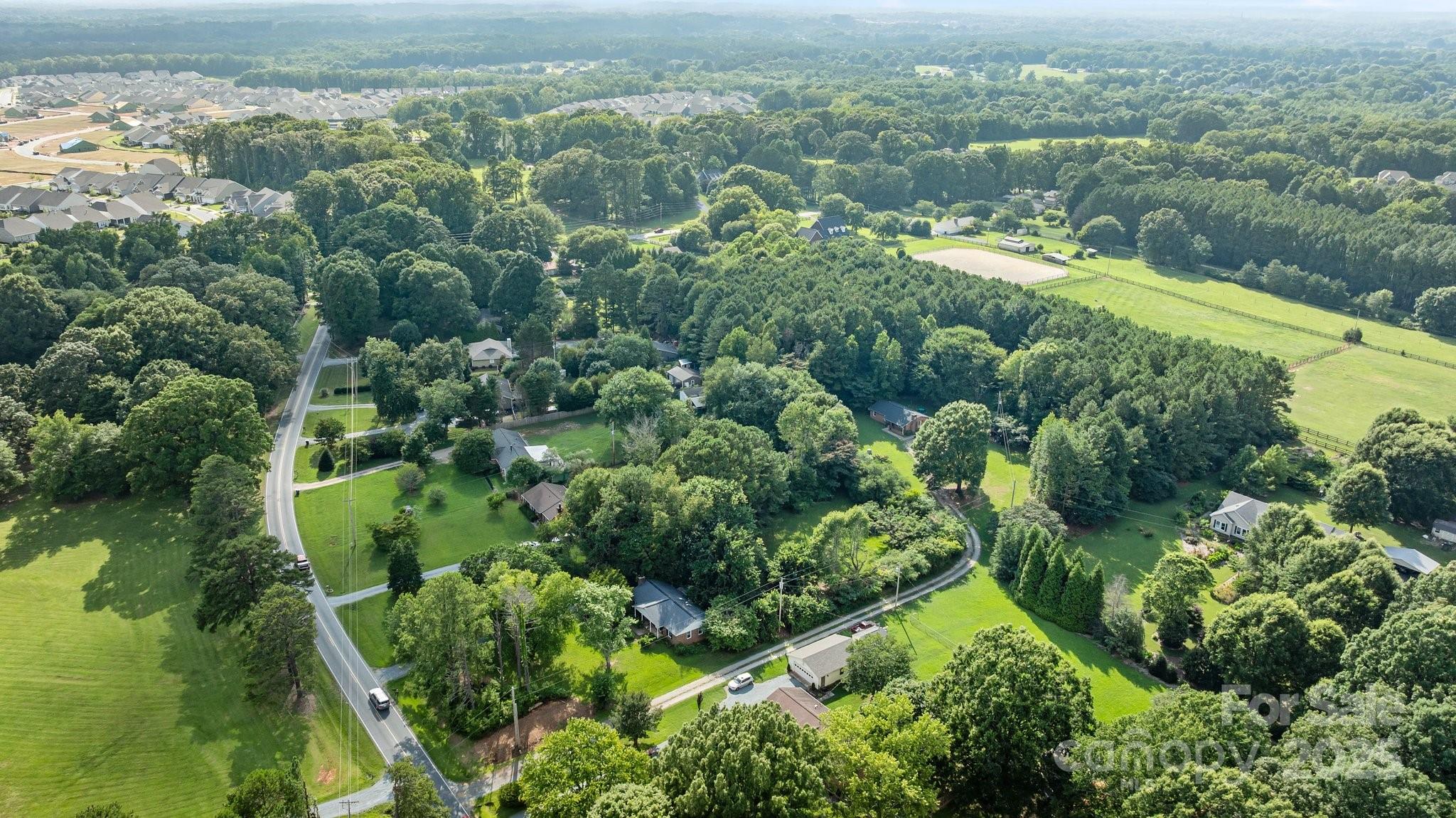 1108 Willoughby Road Monroe, NC 28110 - Photo 27 of 40 an aerial view of residential houses with outdoor space and trees