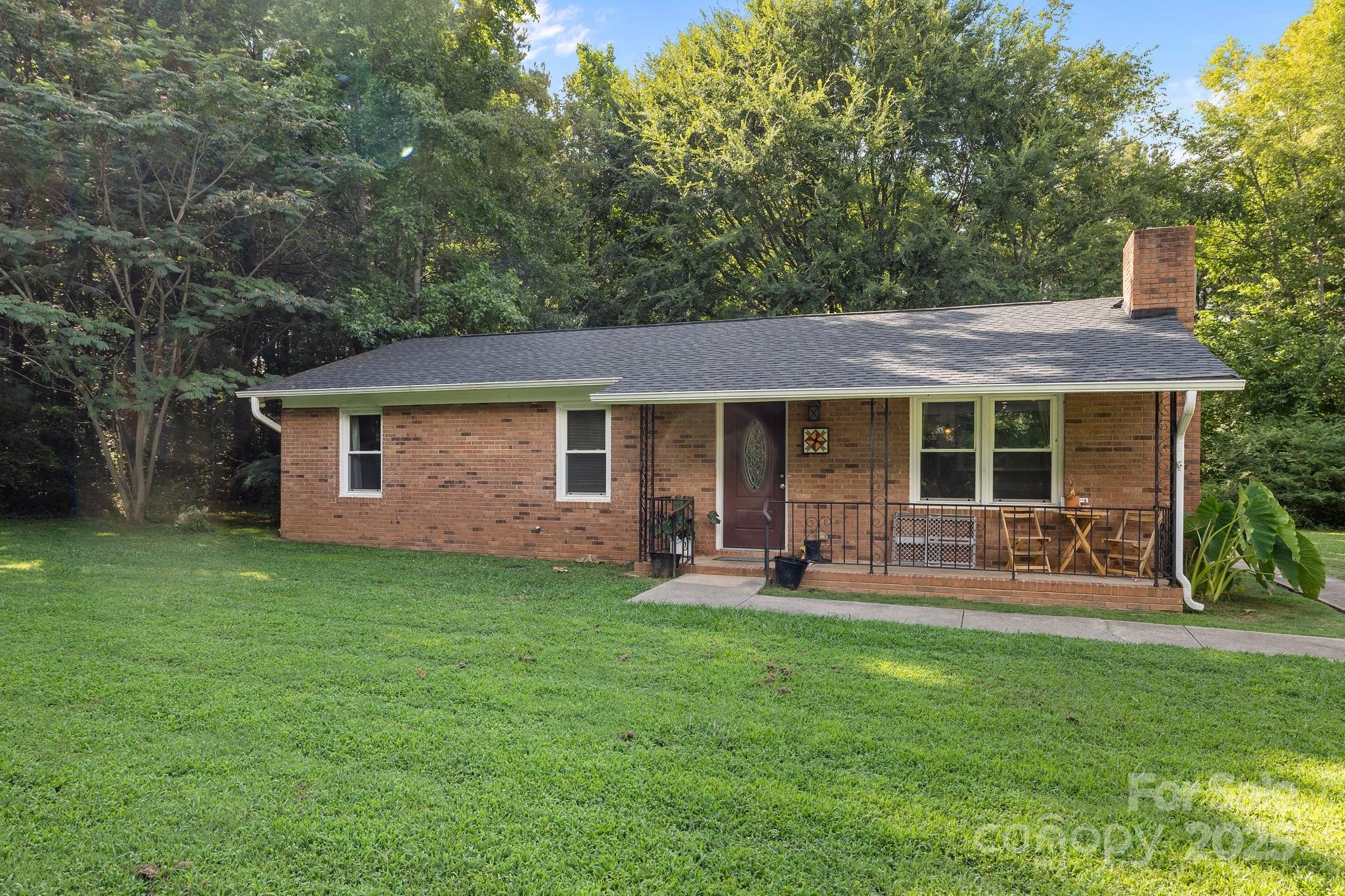 1108 Willoughby Road Monroe, NC 28110 - Photo 3 of 40 a front view of house with a garden and patio