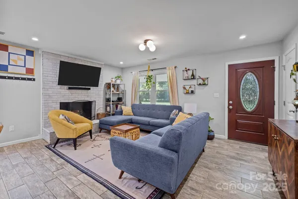 a living room with furniture fireplace and a flat screen tv