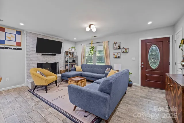 a living room with furniture fireplace and a flat screen tv