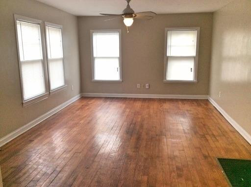 3405 24th Street Lubbock, TX 79410 - Photo 2 of 11 a view of an empty room with wooden floor and a window