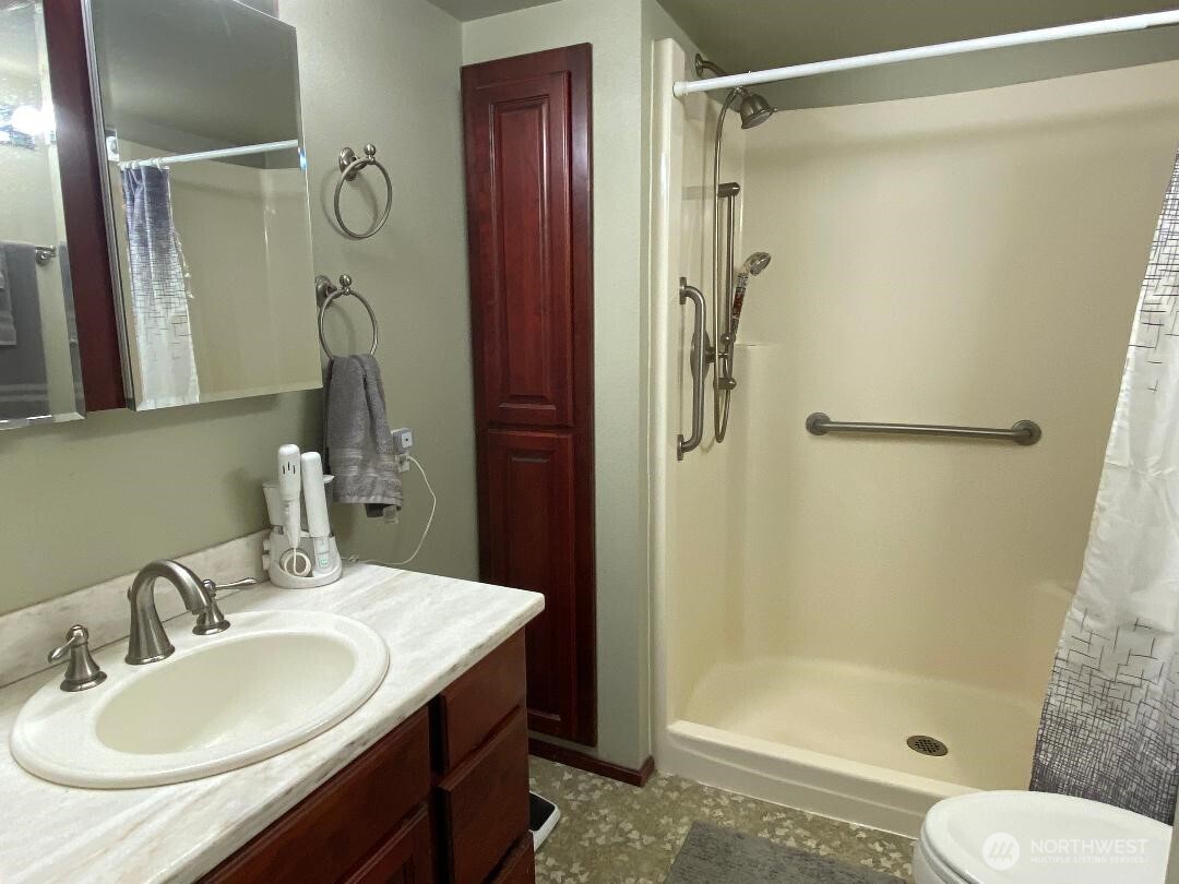 17103 Spanaway Loop Road South, Unit 15 Spanaway, WA 98387 - Photo 11 of 17 a bathroom with a sink toilet and shower