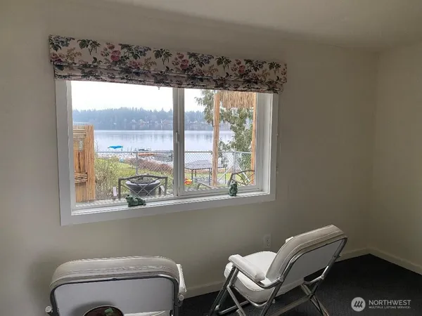 a bathroom with a toilet a sink and a window