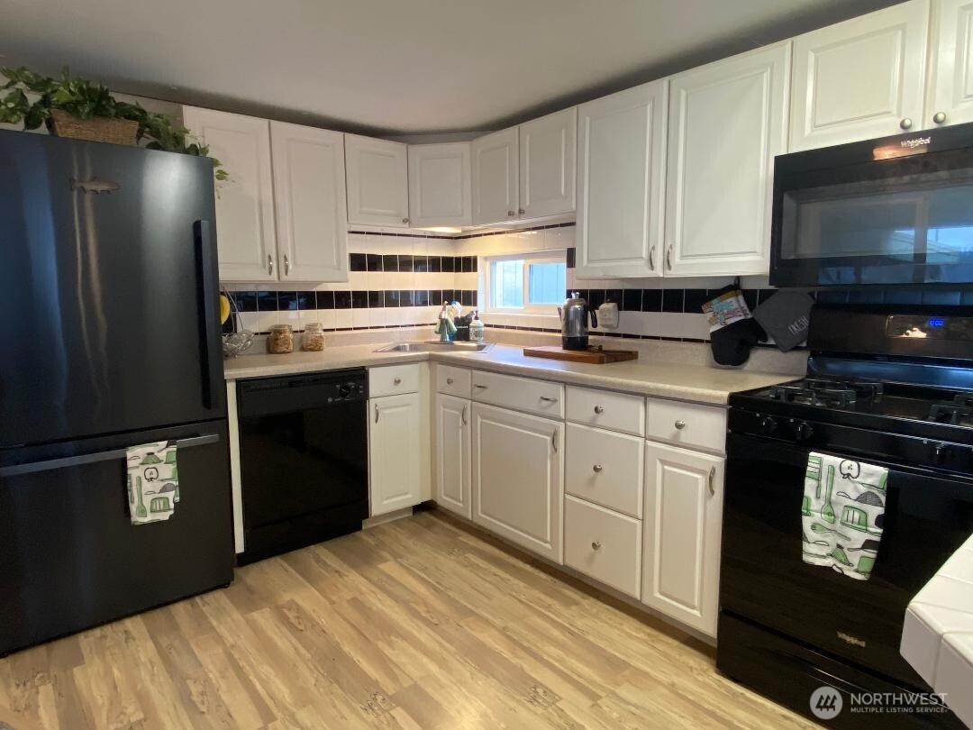 17103 Spanaway Loop Road South, Unit 15 Spanaway, WA 98387 - Photo 5 of 17 a kitchen with a sink stove and refrigerator